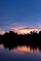 Beautiful sky landscape with sunset over river bank photo