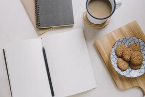notebook near coffee cookies