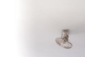 White Orbit ceiling fan on the ceiling of white room photo