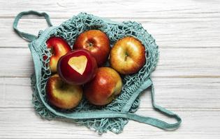 Mesh shopping bag with apples photo