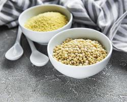 Raw Couscous on table photo