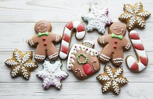Christmas gingerbread with christmas decorations on white wooden photo