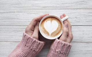 Woman holding cup of coffee photo