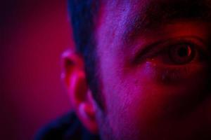 Close up on man face with mysterious facial expression photo