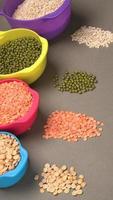 Uncooked pulses,grains and seeds in bowl over grey background. selective focus photo