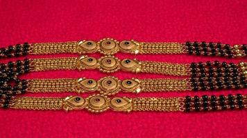 Mangalsutra or Golden Necklace to wear by a married hindu women, arranged with beautiful backgrond. Indian Traditional Jewellery. photo