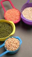 Uncooked pulses,grains and seeds in bowl over grey background. selective focus photo