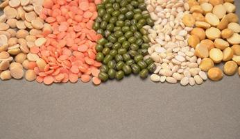 Uncooked pulses,grains and seeds in bowl over grey background. selective focus photo