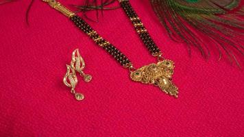 Mangalsutra or Golden Necklace to wear by a married hindu women, arranged with beautiful backgrond. Indian Traditional Jewellery. photo