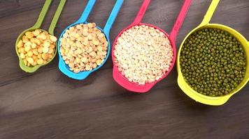 Uncooked pulses,grains and seeds in bowl over grey background. selective focus photo