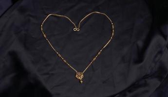 Mangalsutra or Golden Necklace to wear by a married hindu women, arranged with beautiful backgrond. Indian Traditional Jewellery. photo