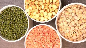 Uncooked pulses,grains and seeds in bowl over grey background. selective focus photo