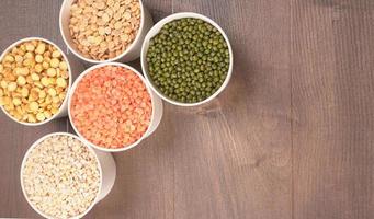 Uncooked pulses,grains and seeds in bowl over grey background. selective focus photo