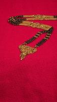 Mangalsutra or Golden Necklace to wear by a married hindu women, arranged with beautiful backgrond. Indian Traditional Jewellery. photo