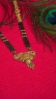 Mangalsutra or Golden Necklace to wear by a married hindu women, arranged with beautiful backgrond. Indian Traditional Jewellery. photo