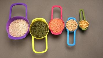 Uncooked pulses,grains and seeds in bowl over grey background. selective focus photo