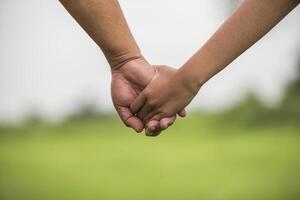 Father and daughter holding hand in hand together photo