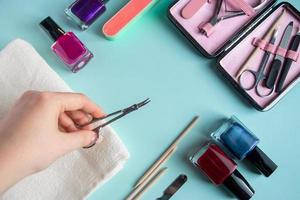 Workplace in a nail salon. A set of tools for hand care on blue background. Place for text. photo