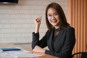 New asian female executives are working in the office. She is proud.
