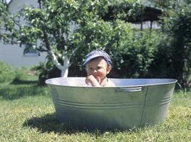 Beautiful baby boy in child tub posing photographer photo