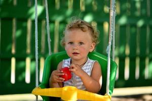 Beautiful baby boy with child swing posing photographer photo