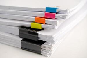 Stack of report paper files in business office clips. photo