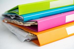 File Folder Binder stack of multi color on table in business office. photo