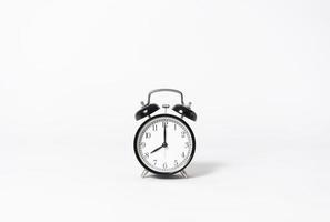 Black alarm clock on gray background. minimal object creative idea. photo