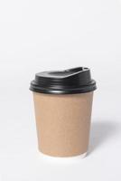 Black brown coffee paper cup on gray background. mock up for branding. photo