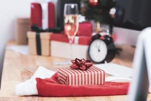 Red gift box in christmas holiday at the office with christmas decoration on table. photo