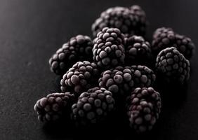 frozen blackberries on wooden table