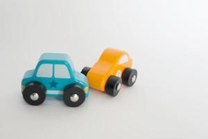 Car crash of two wooden toy cars blue and yellow photo