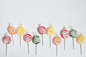 Joyful composition with colorful lollipops with white background photo