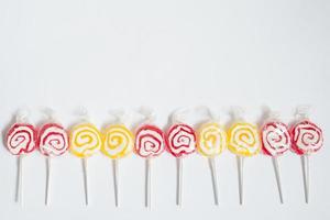 Pattern with red and yellow lollipops in a row photo