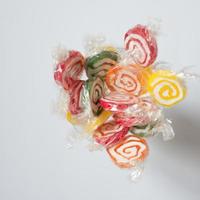 Handful of colorful lollipops seen from above. Red, green, yellow and orange. photo