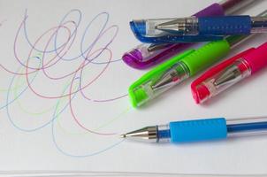 Set of new colorful pens for the school. Drawings on a white paper. Back to school photo