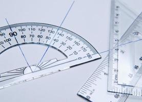 Shool materials for drawing. Bevel, square and angle meter on a white paper photo