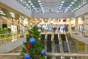 Christmas tree on a blurry background of the railway station photo