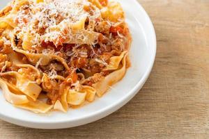 Homemade pasta fettuccine bolognese with cheese photo