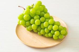 fresh green grape on wood plate photo