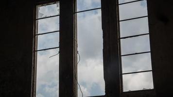 Broken window in an abandoned building photo