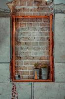 Window sealed with red bricks in an abandoned building