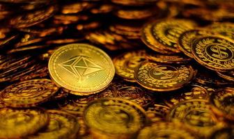 Ethereum coin cryptocurrency on pile gold coins a lot of photo