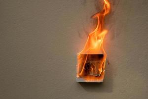 On fire switch electric shock on concrete wall photo