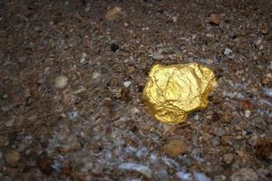 Pure gold nugget ore found in mine with natural underwater sources photo