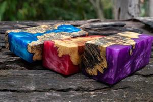 Casting epoxy resin burl wood cube on old table art background photo