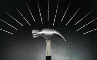 Hammer and nails on dark background photo