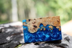 Casting epoxy resin maple burl wood on the table photo