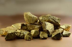 Group fo gold nugget at the golden background photo