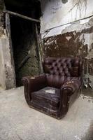 Old abandoned leather armchair photo